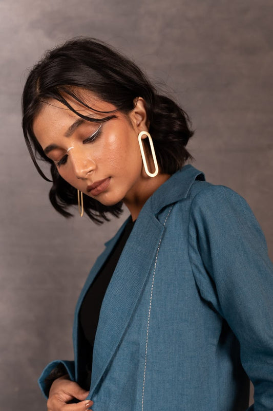 Woman wearing a blue jacket against a gray background